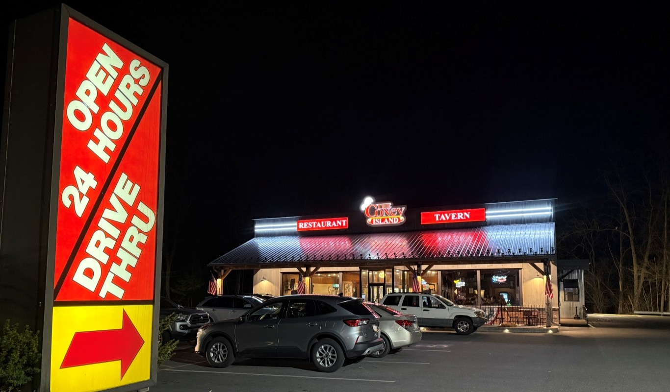 The Coney Island drive-thru sign at night with Restaurant and Tavern neon
